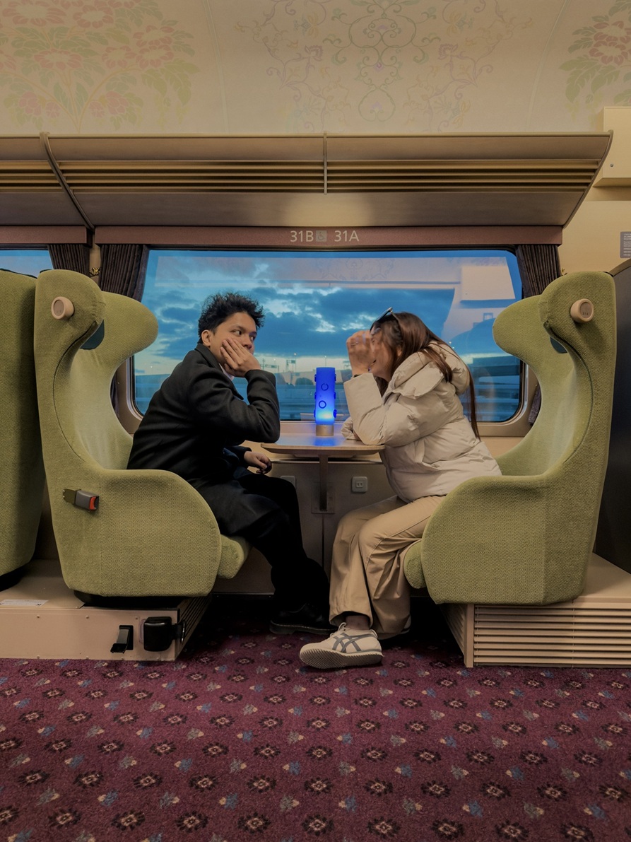 Clarence and Laine on the train, December 2026