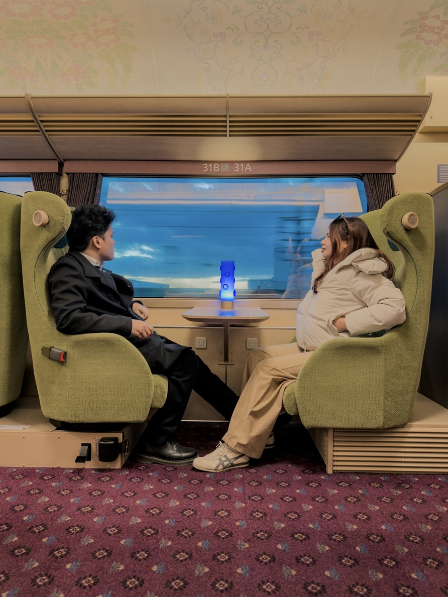 Clarence and Laine on the train, December 2026